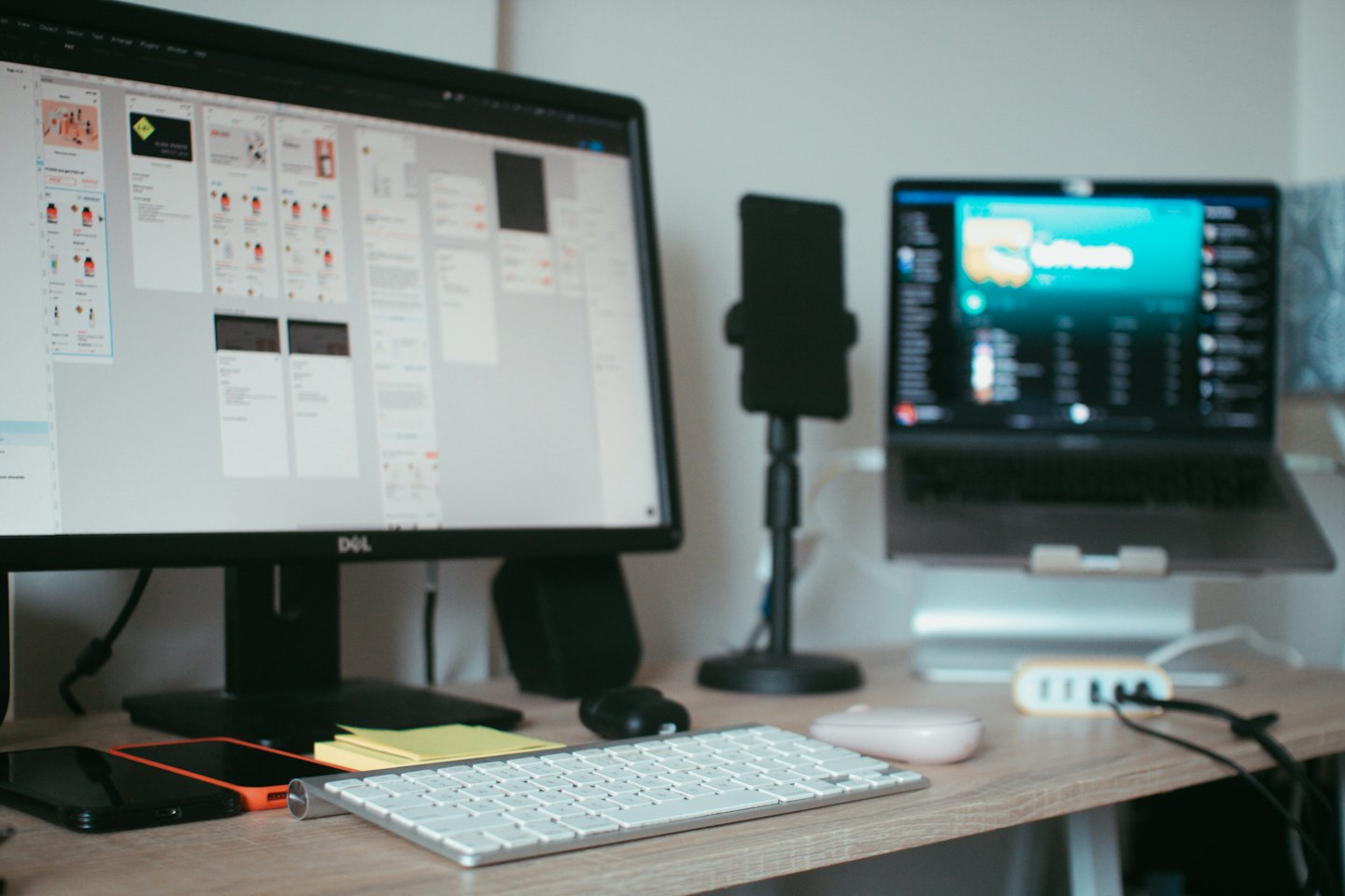 Modern home office desk with dual monitors and tech accessories.